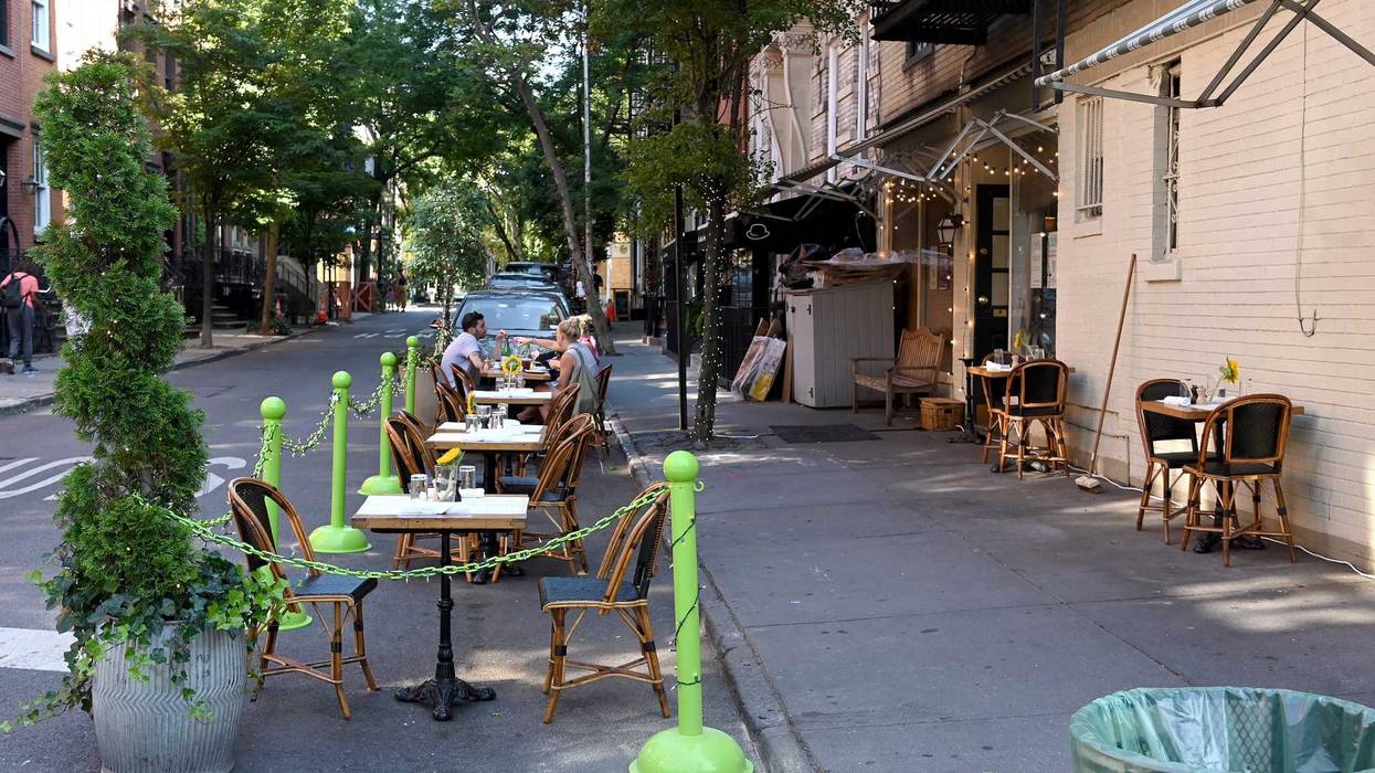 A restaurant in the West Village serves customers seated at sidewalk tables as the city moves into Phase 2 of re-opening following restrictions imposed to curb the coronavirus pandemic on June 22, 2020 in New York City.