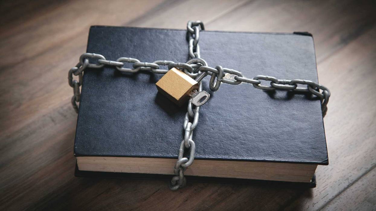 A restricted book with chains and a lock on it.