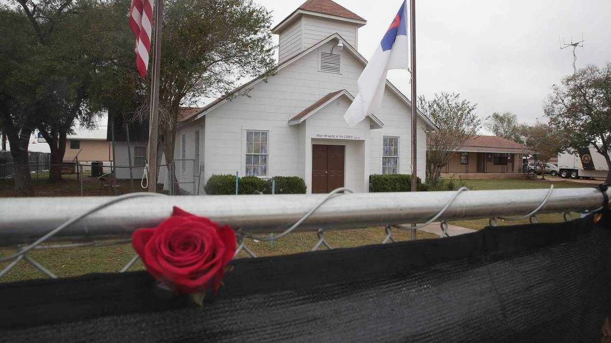 A rose is left in the fence surrounding the First Baptist Church of Sutherland Springs on November 12, 2017, in Sutherland Springs, Texas.