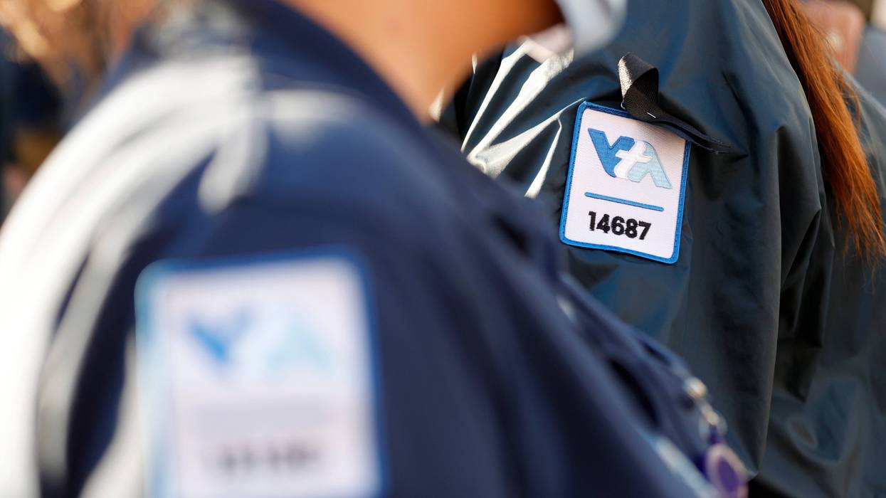 A Santa Clara Valley Transportation Authority (VTA) worker wears a black ribbon on her uniform during a vigil at San Jose City Hall for the 9 victims of a shooting at the Santa Clara Valley Transportation Authority (VTA) light rail yard on May 27, 2021 in San Jose, California.