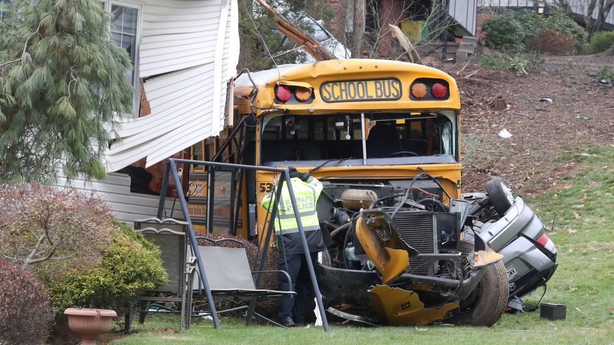 A school bus ran off of Southgate Drive in New Hempstead, hitting a parked minivan and crashed into a house Dec. 1, 2022.