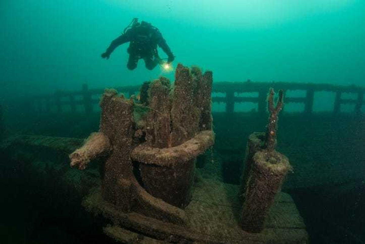 A scuba diver explores an old, wooden shipwreck in Lake Michigan