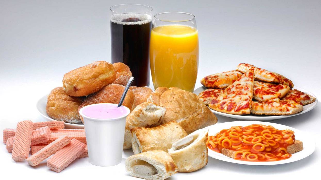 A selection of ultra-processed foods sits on a table.