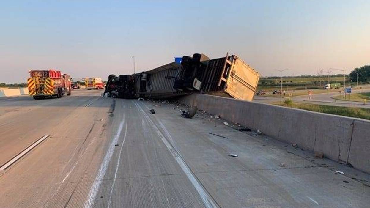 A semitrailer hangs over a retaining wall following a crash June 17, 2020, in the 9000 block of I-94.