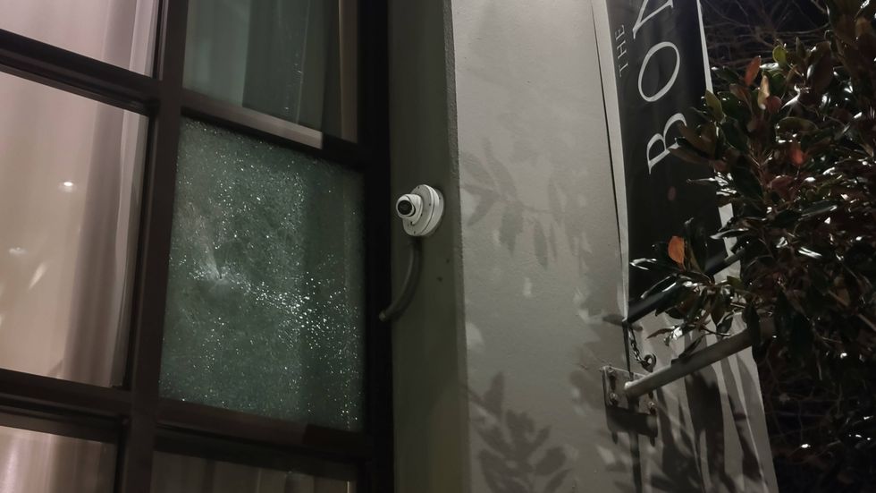 A shattered window at a condominium building next to the Jack London Amtrak station where one person was killed and three others wounded in a New Year