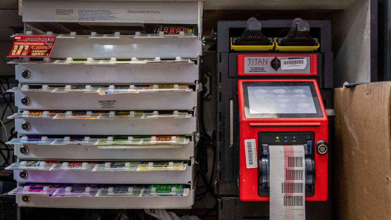 A shelf holding lottery tickets is seen behind a Chevron gas station countertop on July 28, 2022, in Houston City, Texas.