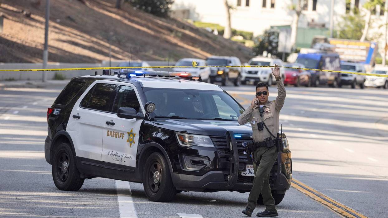 A sheriff's deputy monitors a street closure near the site of an explosion at the LA County Sheriff's Special Operations Bureau on Friday, July 18, 2025, in Los Angeles