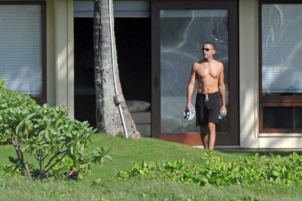 A shirtless Barack Obama is seen as he vacations with his family at a beachside compound on December 21, 2008 in Kailua, Hawaii.