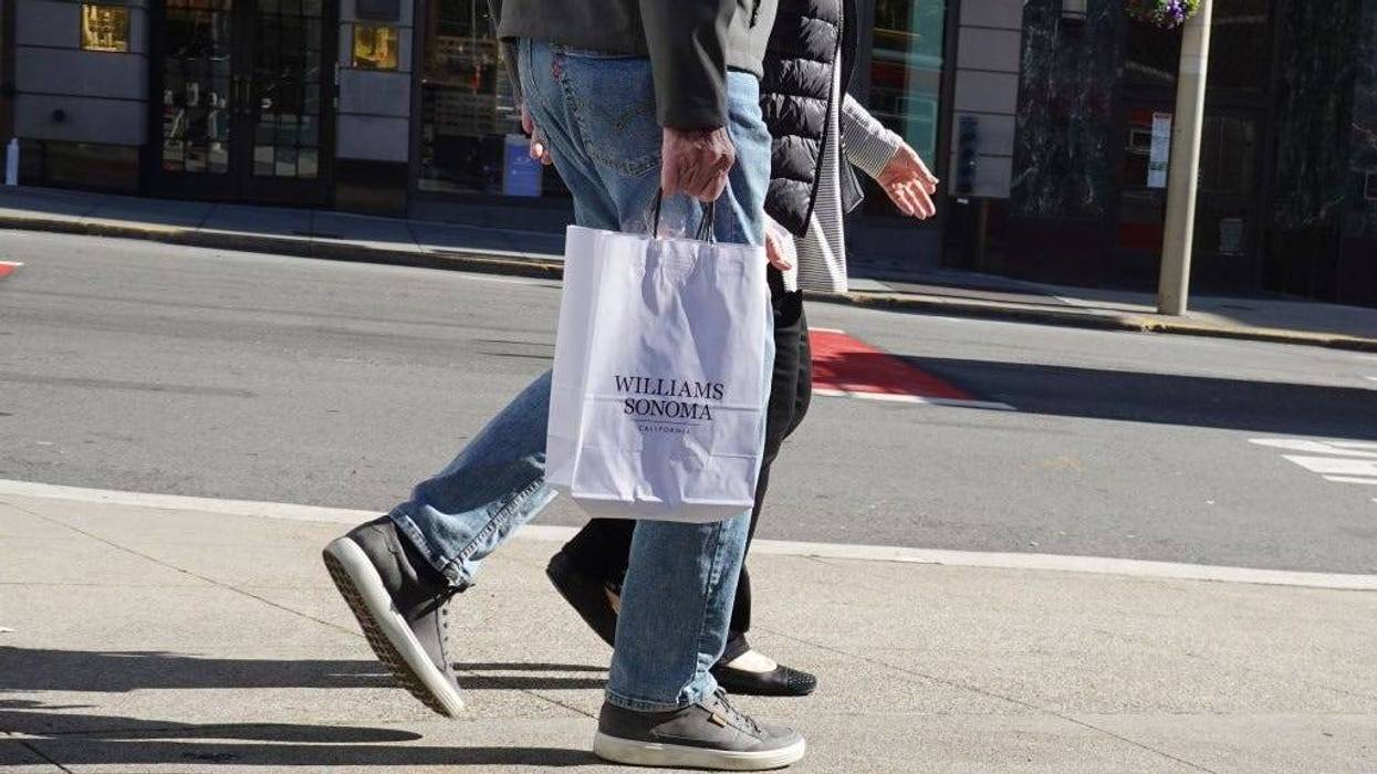 A shopper carries a shopping bag from Williams Sonoma while walking through Union Square on January 27, 2022 in San Francisco, California.