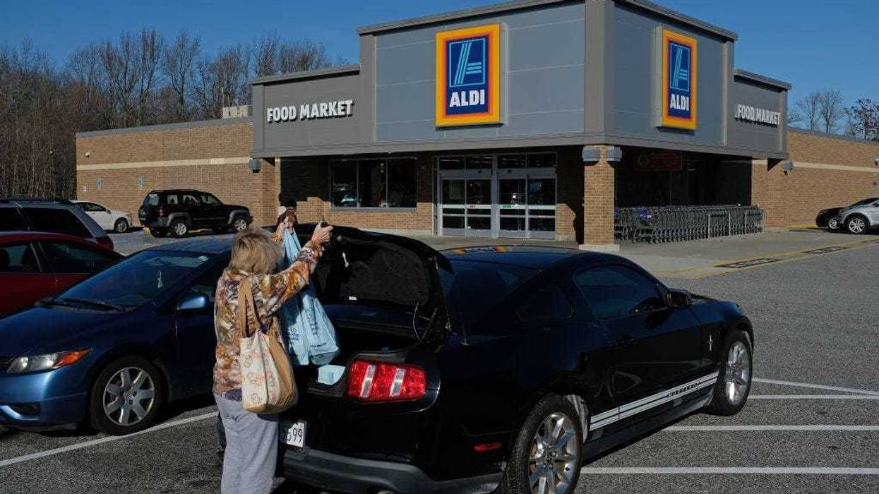 A shopper loads her car outside an Aldi discount grocery store on December 28, 2017 in Edgewood, Maryland.