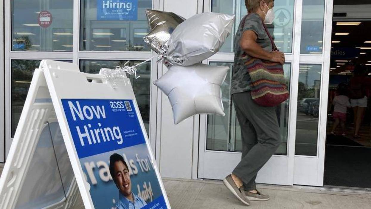 A shopper passes a hiring sign while entering a retail store in Morton Grove, Ill., Wednesday, July 21, 2021. Despite an uptick in COVID-19 cases and a shortage of available workers, the U.S. economy likely enjoyed a burst of job growth last month as it bounces back with surprising vigor from last year’s coronavirus shutdown. The Labor Department’s July jobs report Friday, Aug. 6 is expected to show that the United States added more than 860,000 jobs in July, topping June’s 850,000, according to a survey of economists by the data firm FactSet.