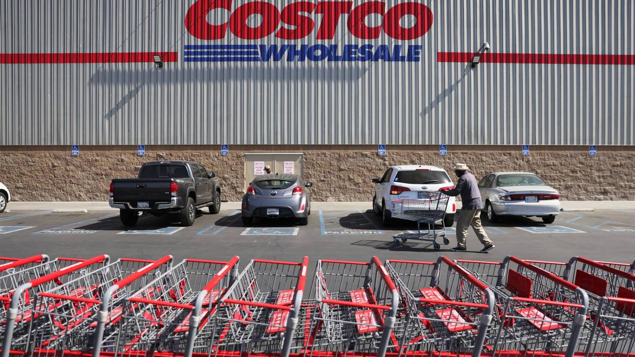 A shopper walks in front of a Costco store.