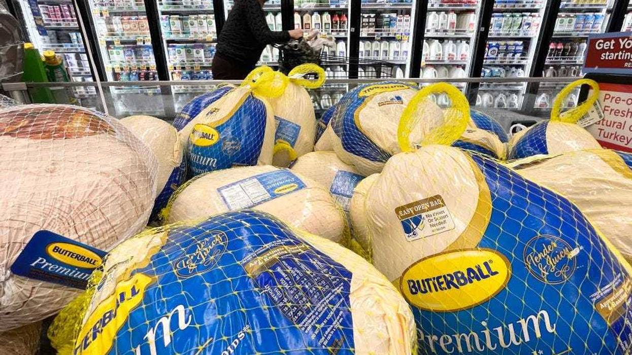 A shopper walks past turkeys for sale in a grocery store ahead of the Thanksgiving holiday on November 11, 2021 in Los Angeles, California.