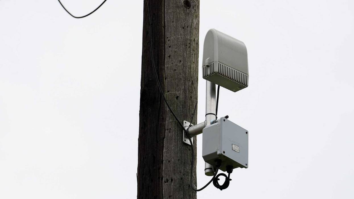 A ShotSpotter device is seen on a pole