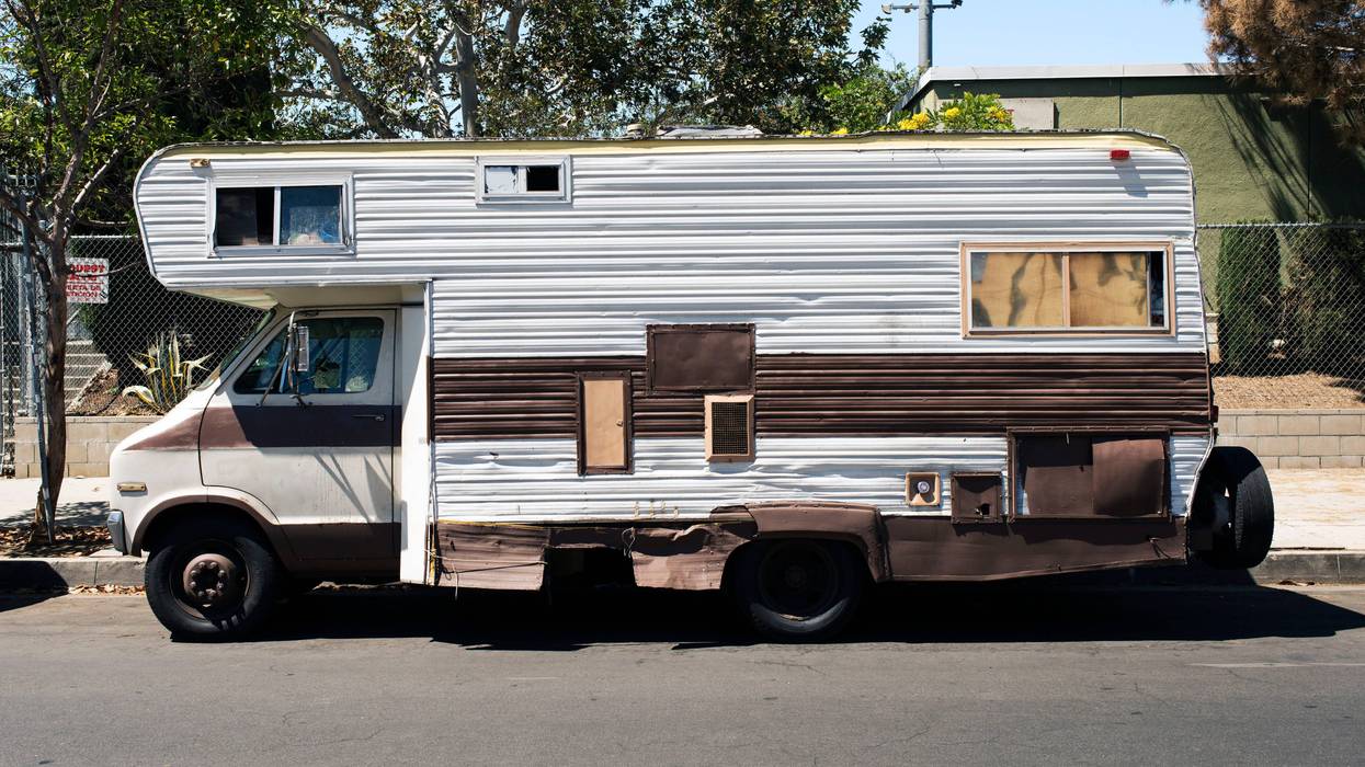 A side view of a vintage RV Van in the street