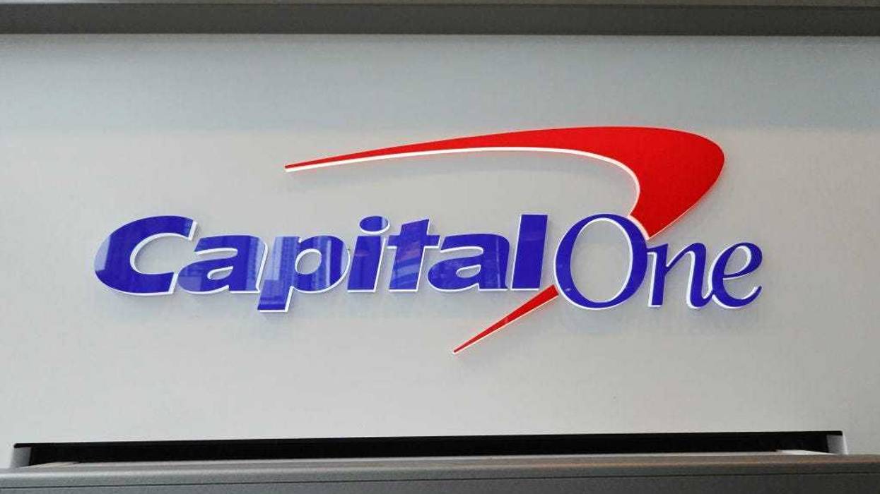 A sign above an ATM at a Capital One Café on February 19, 2024, in Miami, Florida. Capital One announced plans to buy Discover Financial Services in a deal that, if completed, would merge two of the largest credit card companies in the United States. (Photo by Joe Raedle/Getty Images)