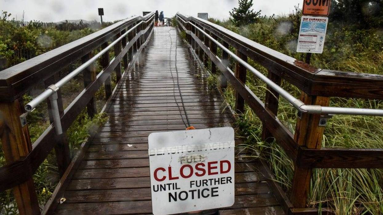 A sign announces the closure of the beach on August 22, 2021 in Montauk, New York. Tropical Storm Henri was downgraded from a Category 1 Hurricane on Sunday morning as heavy rain pounded the east end of Long Island.