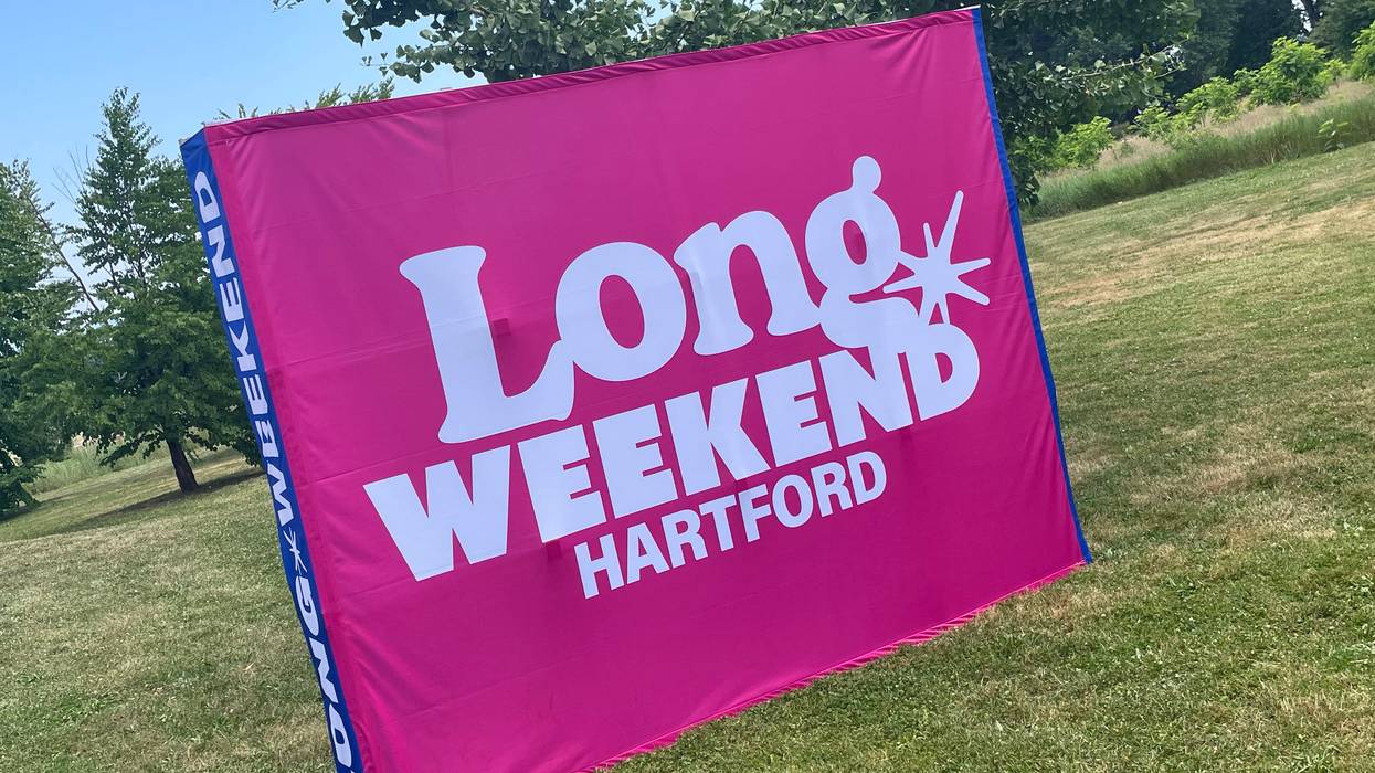 a sign at Colt Park in Hartford reads "Long Weekend Hartford," marking the city's 5-day event marking America 250