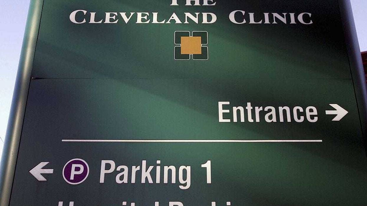 A sign directing visitors to the emergency room stands outside The Cleveland Clinic in Cleveland, Ohio.