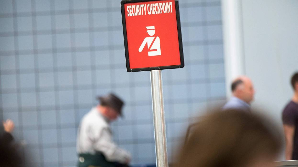 A sign directs travelers to a security checkpoint staffed by TSA workers at O'Hare Airport on June 2, 2015, in Chicago, Illinois.