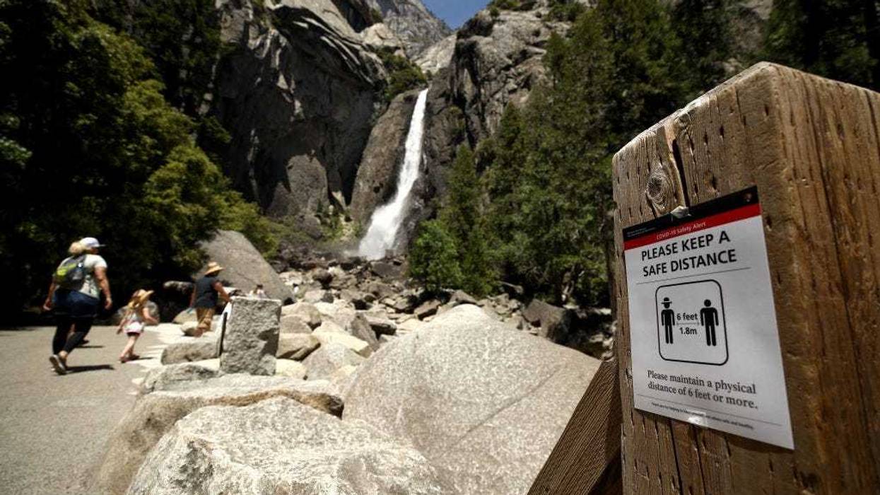 A sign explaining social distancing at Yosemite Falls on June 11, 2020 in Yosemite National Park, California.