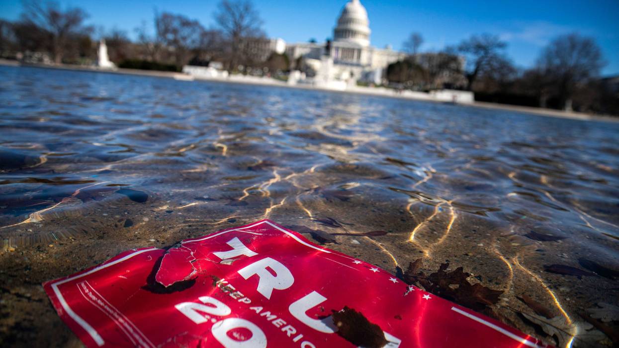 A sign for President Donald Trump's 2020 campaign floats in a pool outside Capitol Hill days after the January 6th insurrection.
