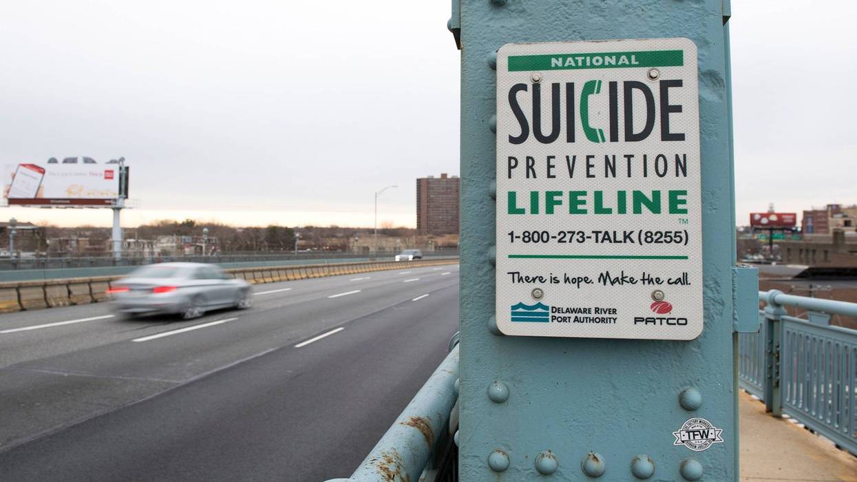 A sign for the National Suicide Prevention Hotline on the Benjamin Franklin Bridge.