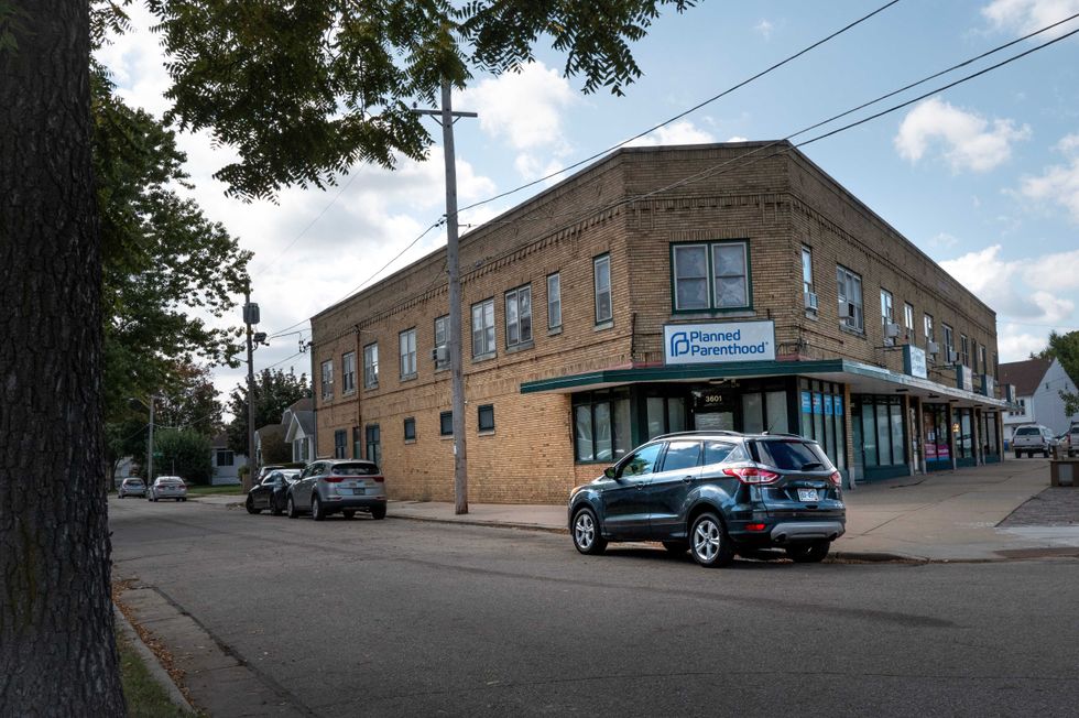 A sign hangs above the front door of a Planned Parenthood clinic on September 25, 2025 in Kenosha, Wisconsin. Planned Parenthood of Wisconsin will reportedly pause scheduling abortion appointments starting Oct. 1, due to fears of losing Medicaid funding because of a provision in the Trump administration