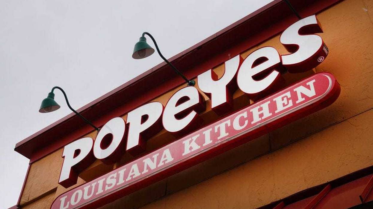 A sign hangs outside of a Popeyes Louisiana Kitchen restaurant on May 06, 2021