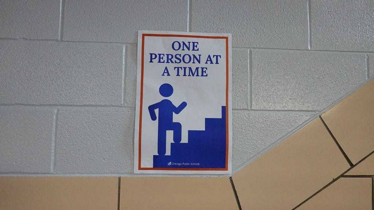 A sign in a hallway at King Elementary School encourages social distancing as the school works to maintain a safe environment during the coronavirus pandemic on September 08, 2020 in Chicago, Illinois.