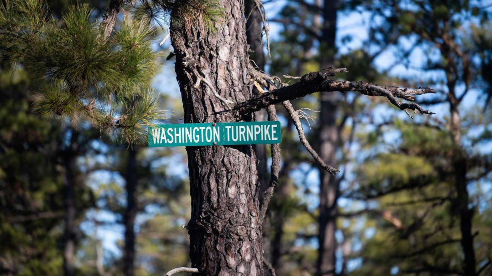 A sign is posted on Washington Turnpike in the Pine Barrens, about 7 miles away from the site where a pilot and a photog were killed when Action News