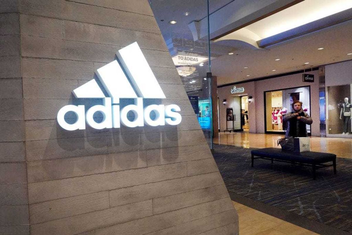 A sign marks the location of an Adidas store inside of a shopping mall on February 10, 2023 in Chicago, Illinois.