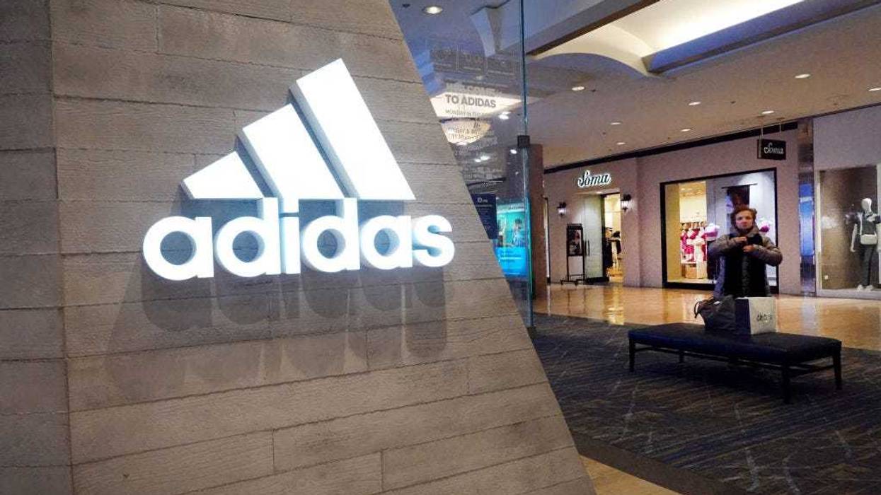 A sign marks the location of an Adidas store inside of a shopping mall on February 10, 2023 in Chicago, Illinois.
