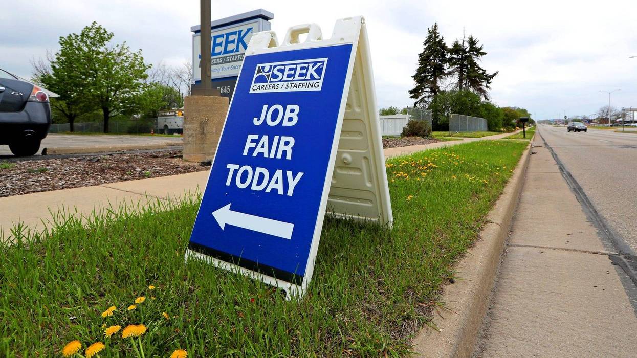 A sign promoting a job fair is seen at SEEK Careers/Staffing on North 76th Street in Milwaukee on Monday, May 3, 2021.