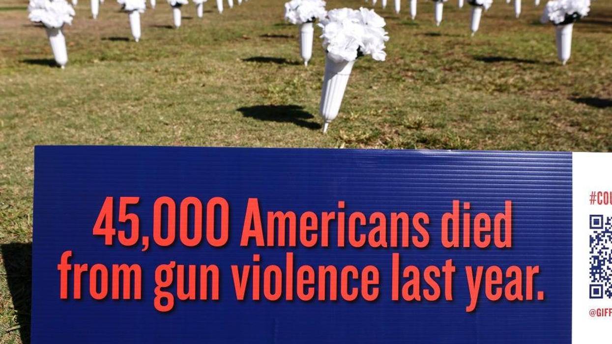 A sign reading '45,000 Americans died from gun violence last year' is posted at an art installation of flowers honoring the 3,200 California residents killed last year due to gun violence on October 19, 2021 in Los Angeles, California.