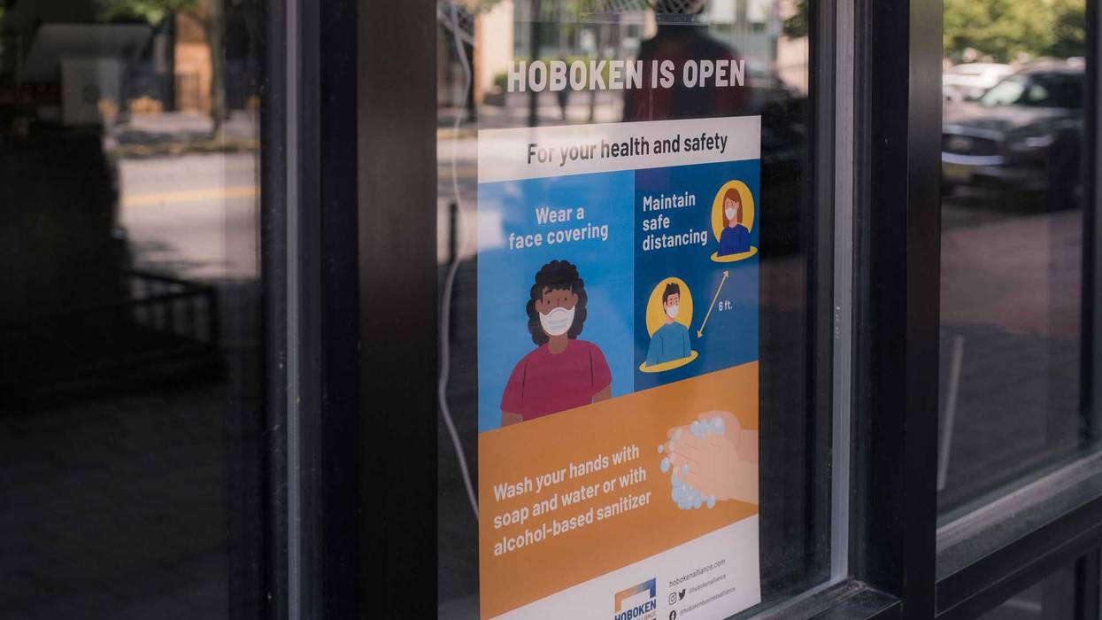 A sign reading Hoboken Is Open is displayed in the window as the city reopens from the coronavirus lockdown on June 15, 2020 in Hoboken, New Jersey.