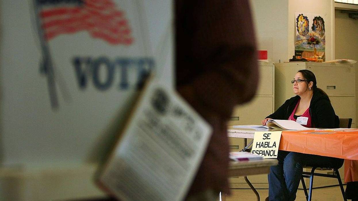 A sign reading, "Se habla Espanol", identifies a bilingual election official as voters go to the polls for Super Tuesday primaries in the predominantly Latino neighborhood of Boyle Heights on February 5, 2008 in Los Angeles, California.