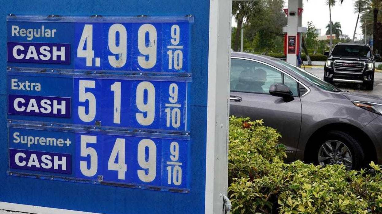 A sign reflects the price per gallon of fuel at a gas station on March 10, 2022 in Miami, Florida