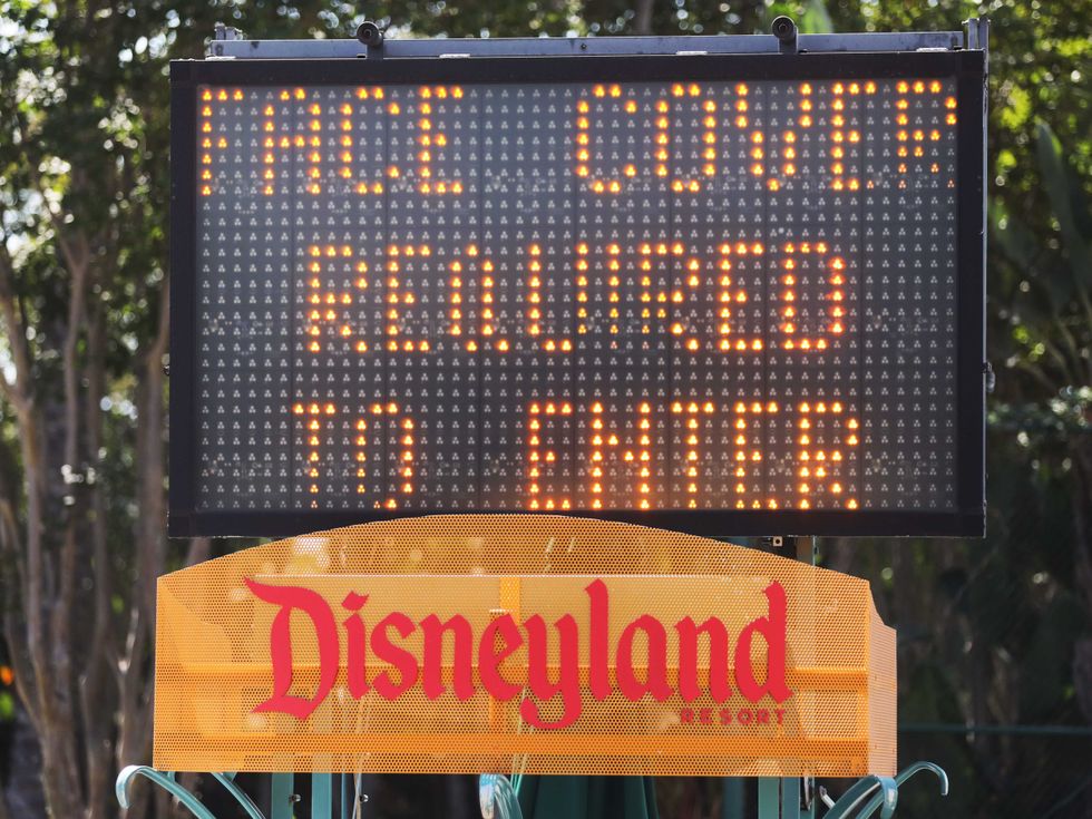 A sign requiring face coverings is posted near an entrance for Downtown Disney District on September 30, 2020 in Anaheim, California.