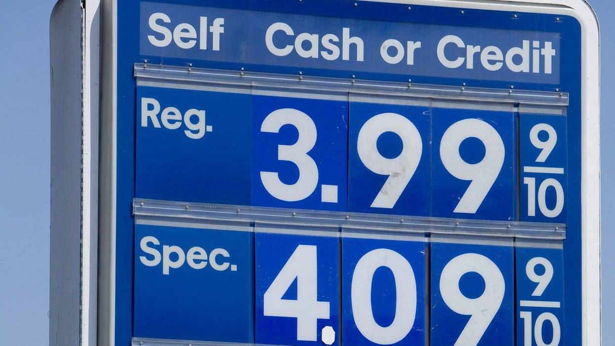 a sign shows high gas prices
