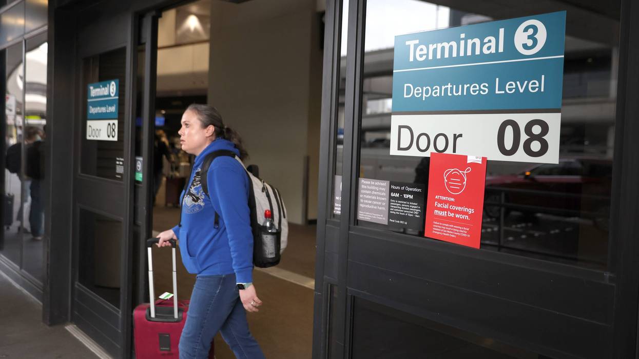 A sign stating that masks are required at San Francisco International Airport is posted on a terminal door after the federal mask mandate for airports and pubic transportation was lifted on April 19, 2022 in San Francisco, California.