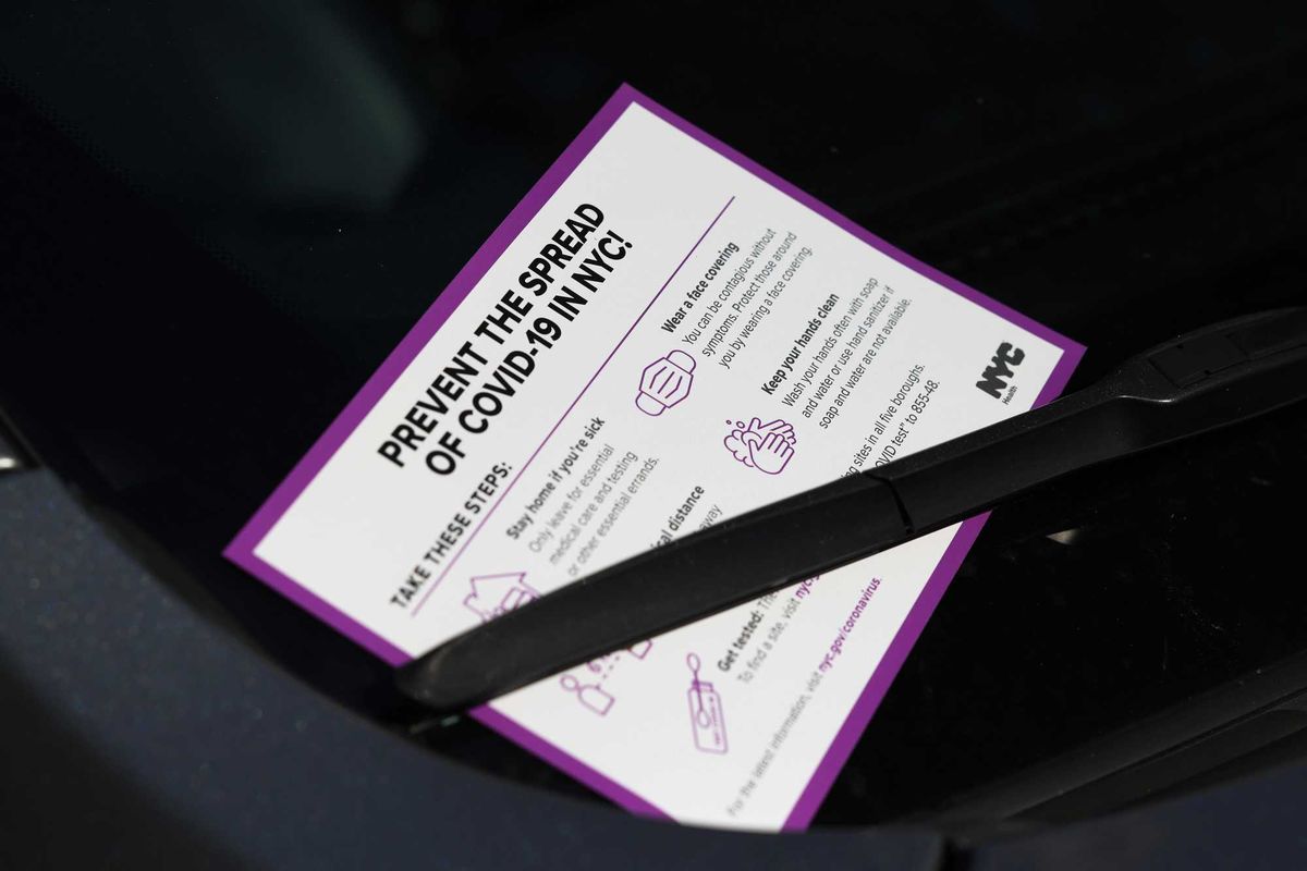 A sign warning of the coronavirus (COVID-19) pandemic is place on the windshield of a car in the Borough Park neighborhood of Brooklyn on October 07, 2020 in New York City.