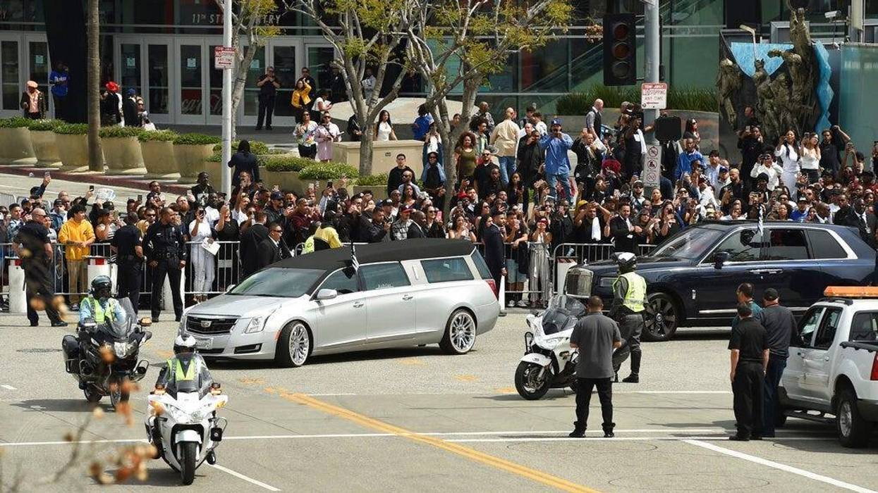 A silver hearse carrying the body of Nipsey Hussle, whose given name was Ermias Asghedom, leaves Staples Center in a procession following the Celebration of Life memorial service for the late rapper on Thursday, April 11, 2019, at the Staples Center in Lo