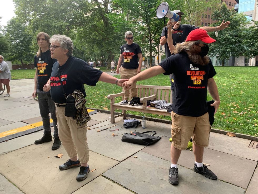 A small group of members of the Communist Party burned three small American flags at the Celebration of Freedom.