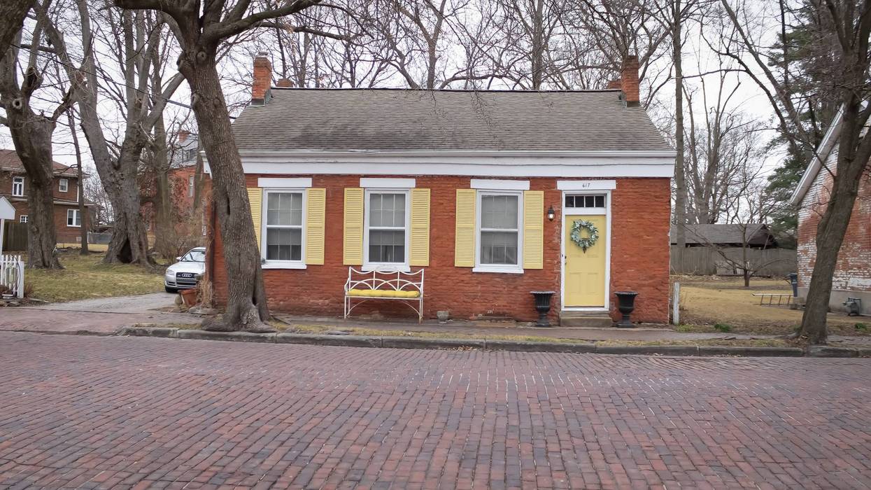 A small orange cottage with yellow shutters in Belleville, Illinois