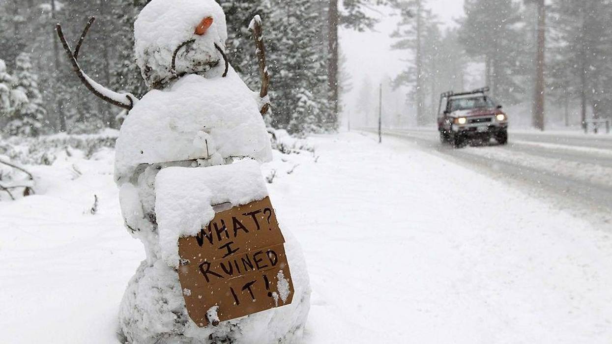 A snowman holds a sign along the race route on Highway 89 after stage one of the 2011 AMGEN Tour of California from South Lake Tahoe to North Lake Tahoe was cancelled due to unsafe conditions caused by snow on May 15, 2011 in South Lake Tahoe, California.