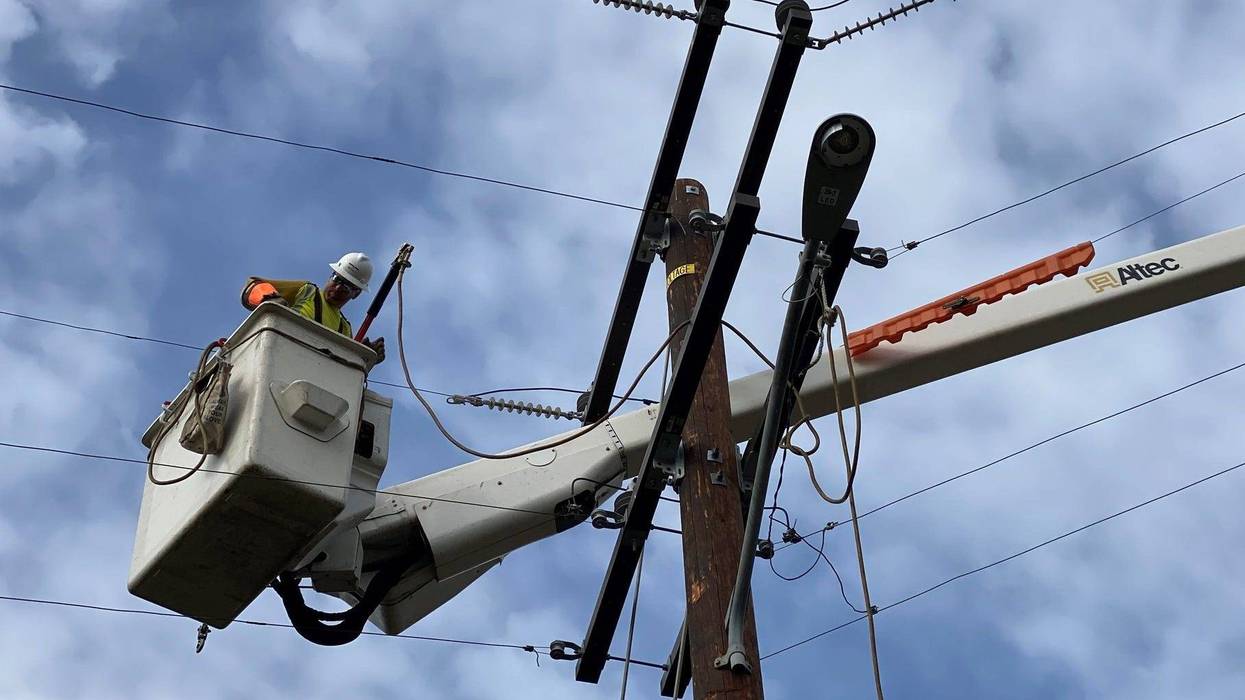 A Southern California Edison contractor works on power lines.