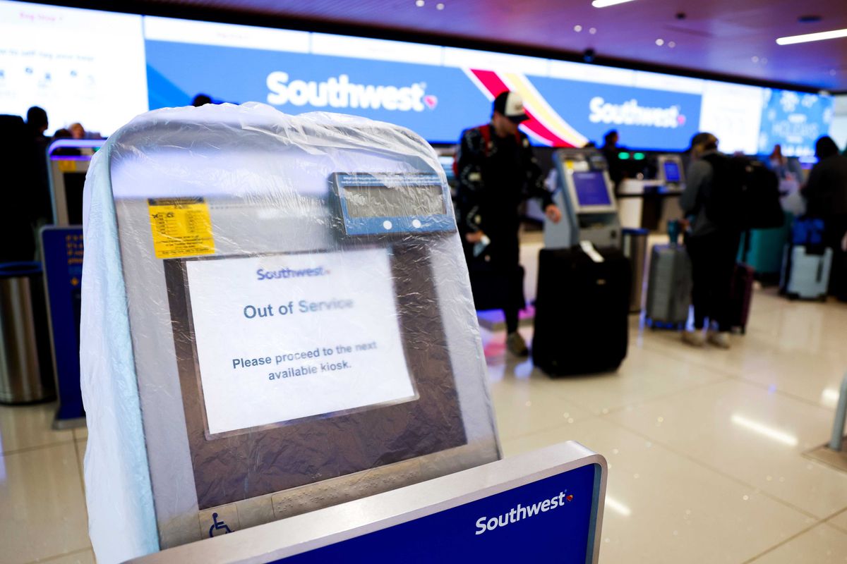 A Southwest Airlines check-in kiosk is covered by plastic as it sits out of service at Denver International Airport on December 28, 2022 in Denver, Colorado. More than 15,000 flights have been canceled between Dec. 22-28 by airlines since winter weather began impacting air travel.