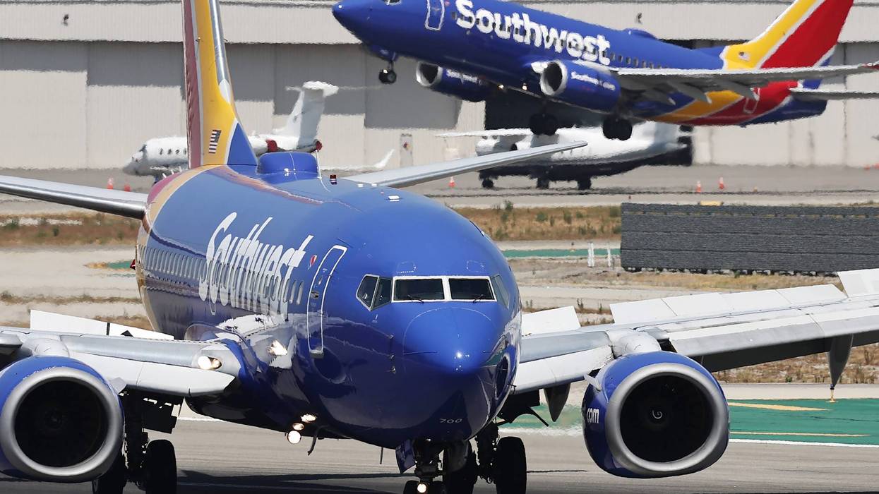A Southwest Airlines plane takes off from Hollywood Burbank Airport as another Southwest plane taxis.