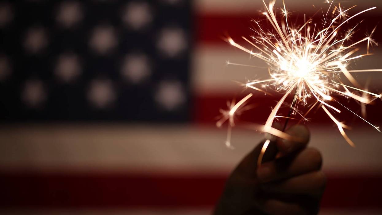 A sparkler and the American flag.